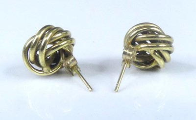 Lot 2579 - A pair of yellow metal double-strand knot stud...