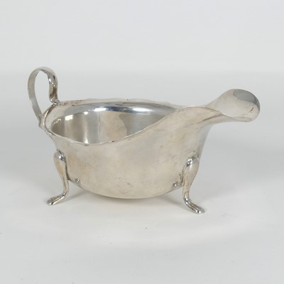 Lot 264 - A George V silver sauce boat, of helmet shape,...