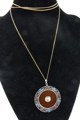 Lot 2585 - A white metal circular pendant, with banded...