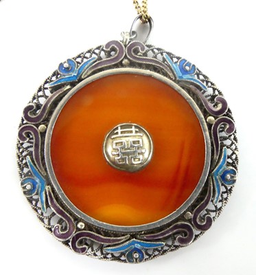 Lot 2585 - A white metal circular pendant, with banded...