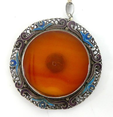 Lot 2585 - A white metal circular pendant, with banded...