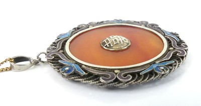 Lot 2585 - A white metal circular pendant, with banded...