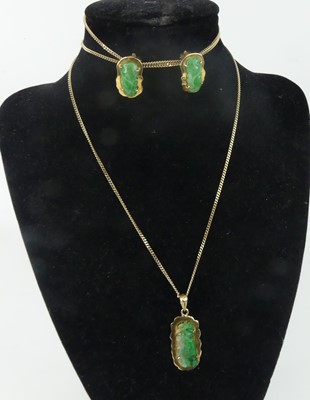 Lot A yellow  metal carved jadeite pendant and...