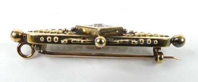 Lot A yellow metal diamond bar brooch, comprising...