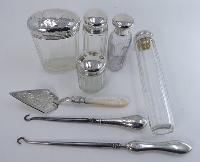 Lot 303 - A collection of five silver topped glass...