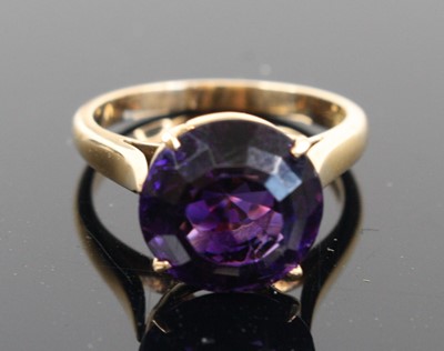 Lot 339 - A yellow metal and purple paste set solitaire...