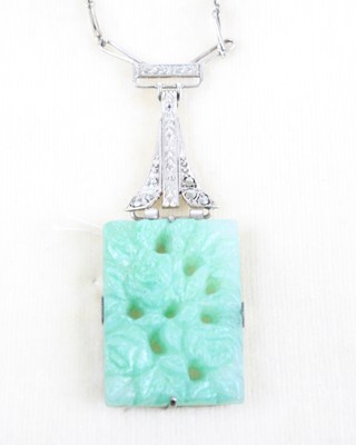 Lot 355 - An Art Deco carved faux jade pendant on silver...