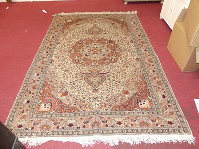 Lot 1158 - A Persian woollen cream ground Tabriz rug, 300...