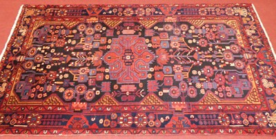 Lot 1161 - A Persian woollen red ground Mahavand rug, 275...