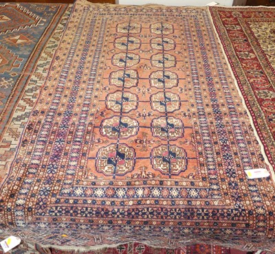 Lot 1174 - A Persian woollen red ground Bokhara rug,...