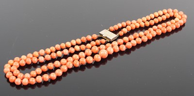 Lot 392 - A beaded coral double-string choker, with...