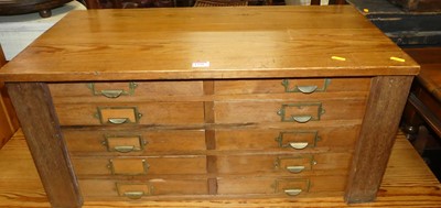 Lot 1256 - A pitch pine table top chest, having twin...