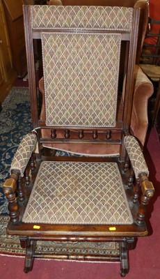 Lot 1326 - A circa 1900 walnut American rocking armchair,...