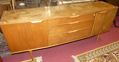 Lot 1299 - A 1960s teak long sideboard, of slightly bowed...