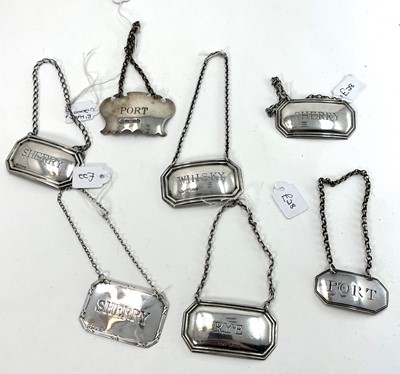 Lot 436 - A collection of seven silver decanter labels,...