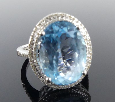 Lot 2511 - A white metal blue topaz and diamond oval...