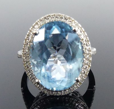 Lot 2511 - A white metal blue topaz and diamond oval...