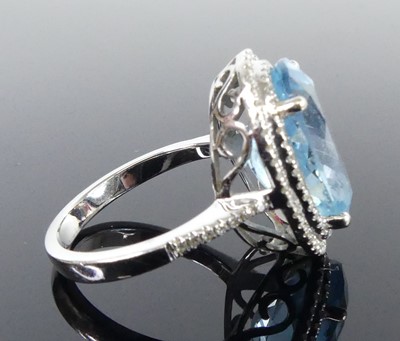 Lot 2511 - A white metal blue topaz and diamond oval...