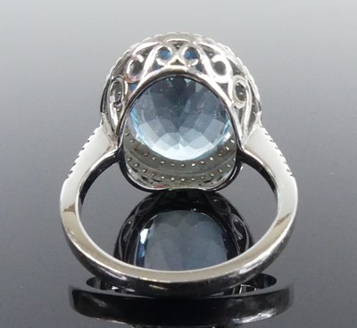 Lot 2511 - A white metal blue topaz and diamond oval...
