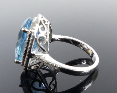 Lot 2511 - A white metal blue topaz and diamond oval...