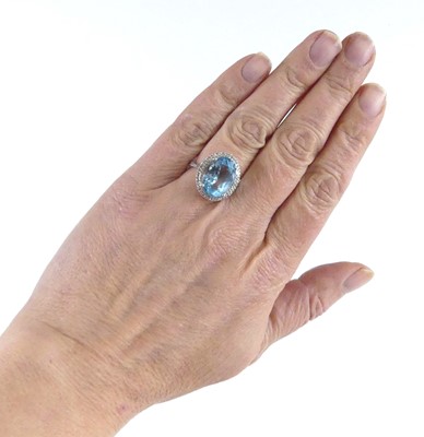 Lot 2511 - A white metal blue topaz and diamond oval...
