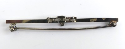 Lot 2519 - A white metal diamond bar brooch, comprising...