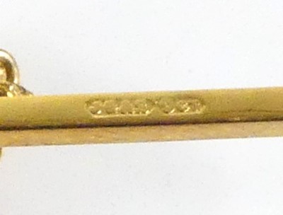 Lot 2521 - A yellow metal bar brooch in the form of a...