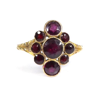 Lot 2516 - A yellow metal garnet navette cluster ring,...