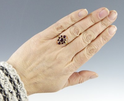 Lot 2516 - A yellow metal garnet navette cluster ring,...
