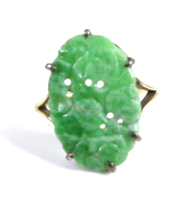 Lot 2522 - A yellow metal jadeite dress ring, comprising...