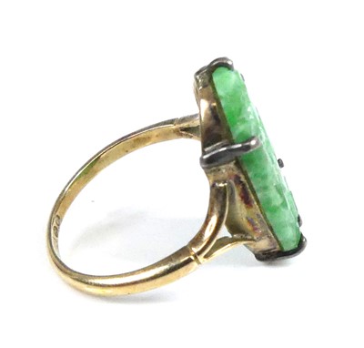 Lot 2522 - A yellow metal jadeite dress ring, comprising...