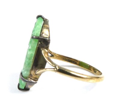 Lot 2522 - A yellow metal jadeite dress ring, comprising...