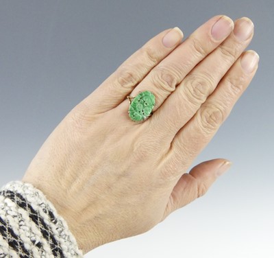 Lot 2522 - A yellow metal jadeite dress ring, comprising...