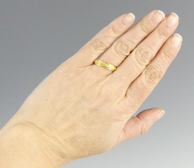 Lot 2594 - A yellow metal 4.7mm D-shaped wedding band...