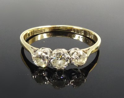 Lot 2595 - A yellow and white metal diamond three-stone...