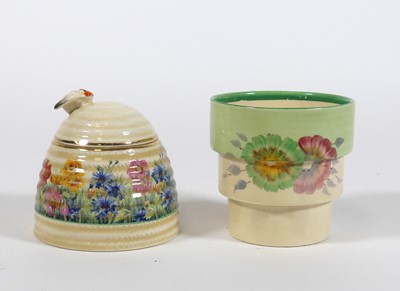 Lot 169 - A Clarice Cliff pottery honey pot and cover,...