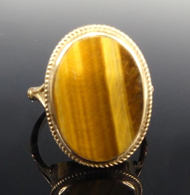 Lot 2547 - A 9ct gold tiger's eye set dress ring, the...