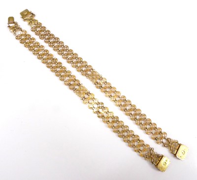 Lot 2548 - A pair of yellow metal bracelets, each...