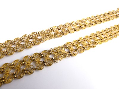 Lot 2548 - A pair of yellow metal bracelets, each...
