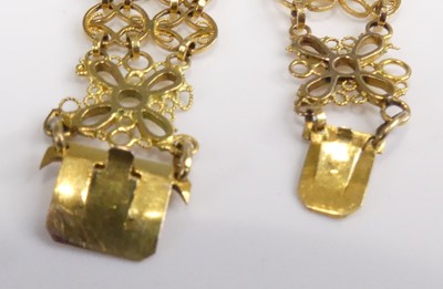 Lot 2548 - A pair of yellow metal bracelets, each...