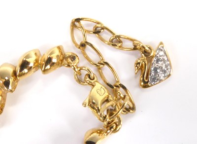 Lot 2555 - A Swarovski gilt metal crystal set hinge...
