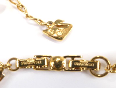 Lot 2555 - A Swarovski gilt metal crystal set hinge...
