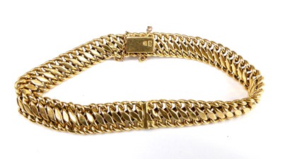 Lot 2561 - A continental yellow metal flatlink bracelet,...