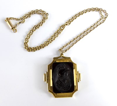 Lot 2735 - A carved carnelian pendant as a profile...