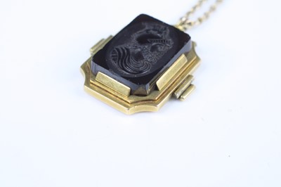 Lot 2735 - A carved carnelian pendant as a profile...
