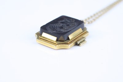 Lot 2735 - A carved carnelian pendant as a profile...