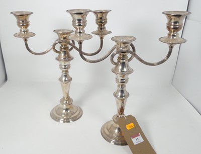 Lot 11 - A pair of silver plated three-branched table...