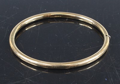 Lot 336 - A modern 9ct hollow gold hinge bangle, dia....