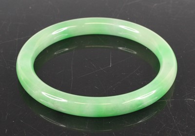 Lot 337 - A Chinese green jade bangle, dia. 8cm, 49.6g