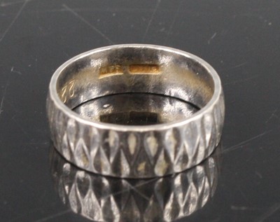 Lot 350 - A carved platinum wedding band, sponsor S&W,...